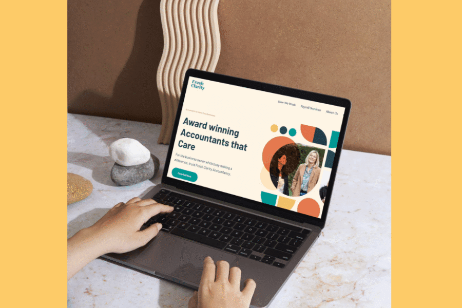 Picture of hands on a laptop on a desk with the Fresh Clarity website on the laptop screen